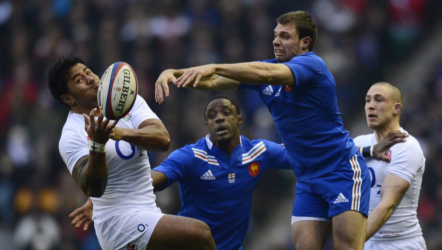 England's Manu Tuilagi challenges France's Vincent Clerc in the air (AFP)
