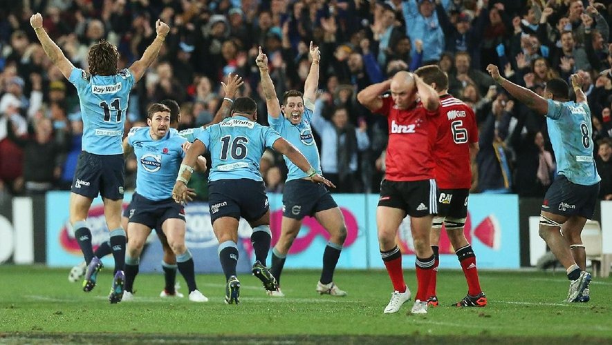 Waratahs players celebrate victory at the end of the Super Rugby Grand Final match between the Waratahs and the Crusaders at ANZ Stadium