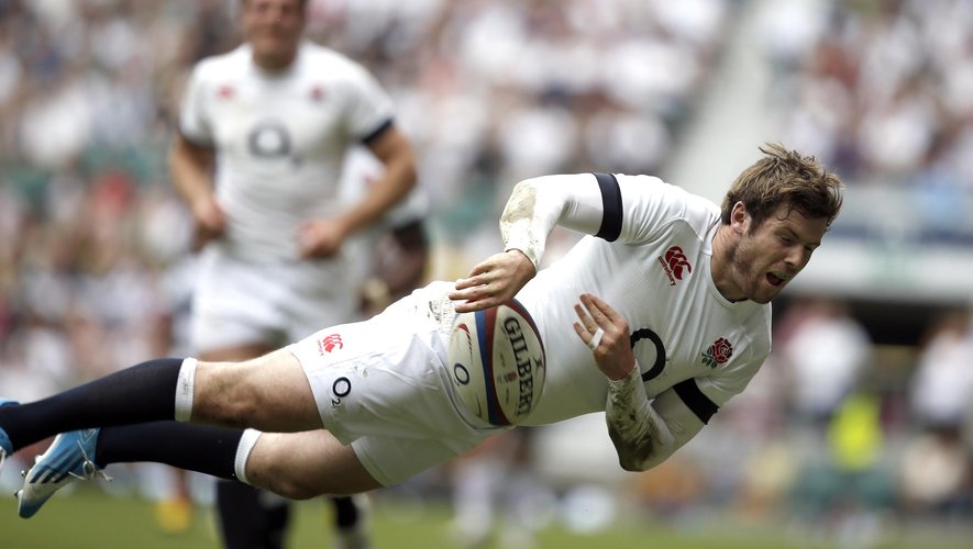 England's full back Elliot Daly dives to keep the ball off the sideline during the Rugby Union match between England and Barbarians at Twickenham Stadium, southwest of London, on June 1, 2014