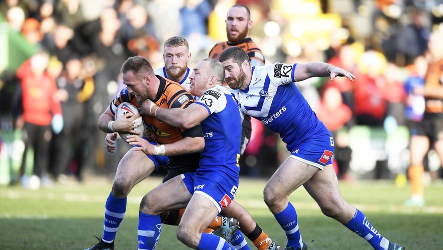 Liam Watts of Castleford is tackled by James Roby of St Helens during the Betfred Super League match between Castleford Tigers and St Helens